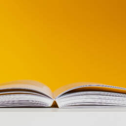 Opened book on a yellow background